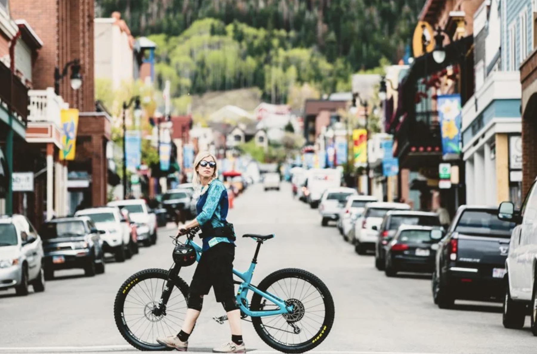 Mountain biker standing with a bike on a town street