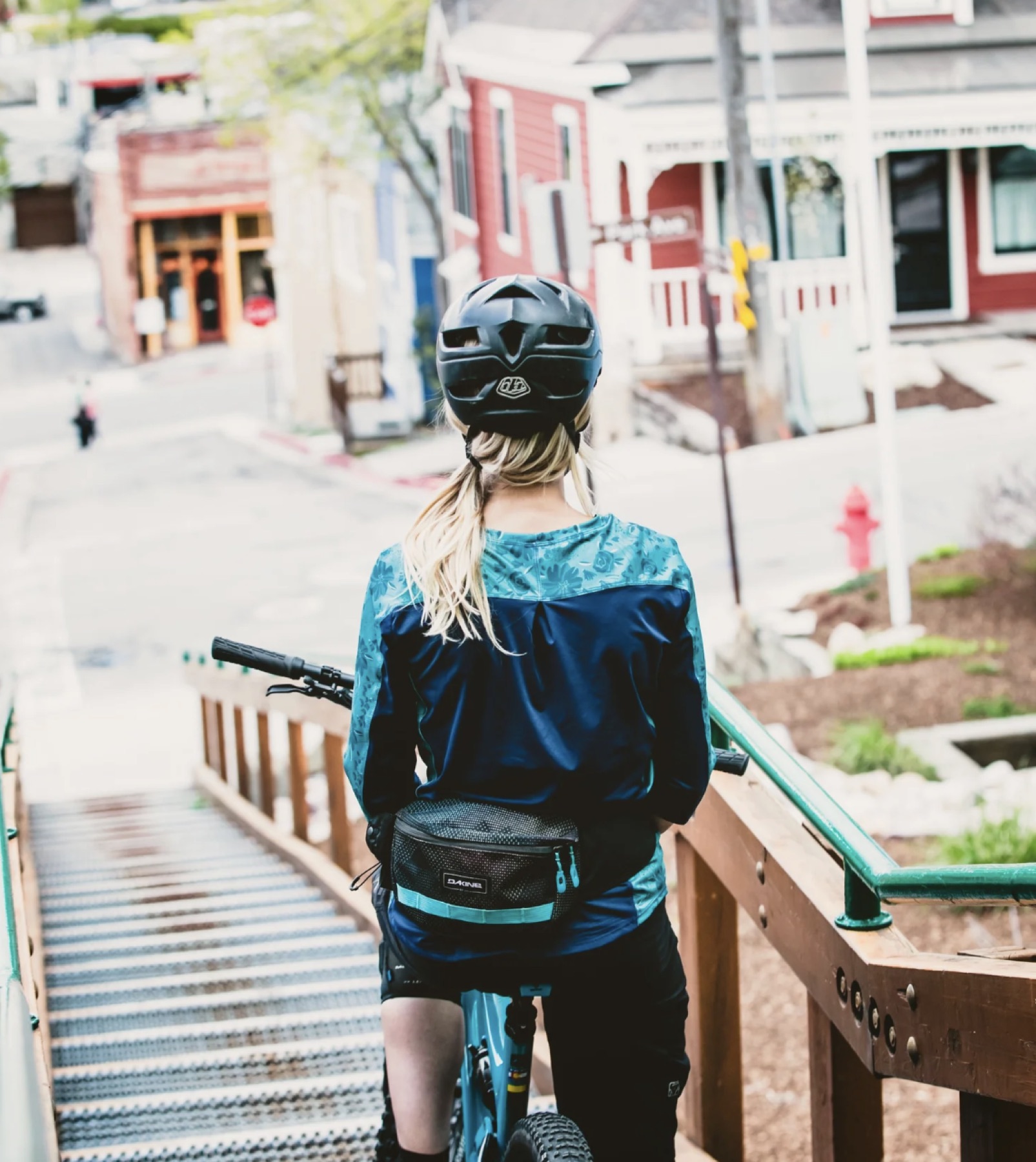 Mountain biker wearing Rock Roselle apparel at the top of town stairs